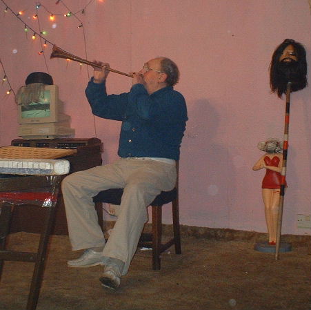 Gordon Cragg seated back from bingo board playing a straight horn